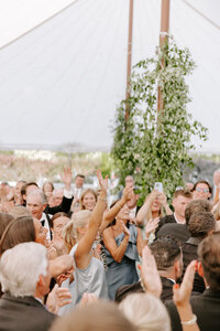 Man and woman laying on the ground while embracing and smiling at each other