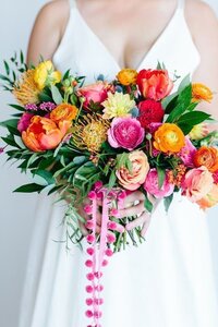 Bright orange, pinks, yellows and green wedding flowers