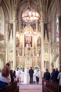 A couple weds in a High Latin Mass ceremony at the National Shrine of St. Alphonsus in Baltimore, Maryland, captured by Nathan Sottung Photography, a wedding photographer specializing in religious ceremonies