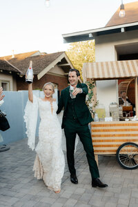 Arizona Wedding Photographer and Videographer Couple Celebrating With Champagne Just Married