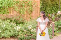 The bride looks to the side as the lattice is seen behind her.