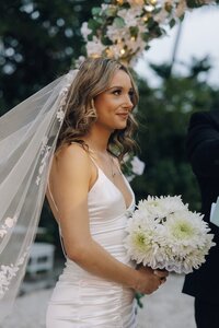 bride holds bouquet for photos at wedding in south florida