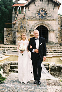 Bride walking arm in arm with her father to the church at Altos de Chavón, beautifully documented by Asia Pimentel.
