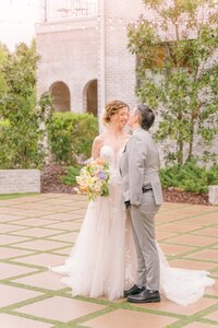 Sophie and Veronica giggle together while they stand in the courtyard at the Bradford.