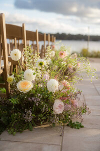 Floral meadow arrangemenet with pastels lining the aisle of outdoor wedding venue in Greater Boston.