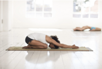 Two women doing yoga in a studio