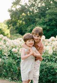 Two brothers play in the rose garden in Vondelpark.