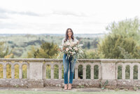 Headshot of Jennifer, founder of Jennifer Louise Weddings, holding a floral bouquet