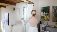 bride looking at wedding dress
