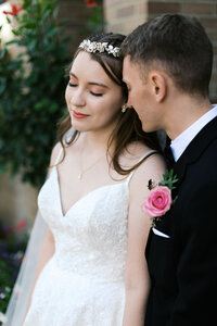 Bride closes her eyes as she gently leans against his head, captured by Minnesota wedding photographer.  