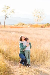 boy hugs his mom at McIntosh Lake, Longmont, CO