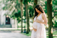 Pregnant woman showing off baby bump at Tiedman Park in Savannah, GA. Maternity photographer Savannah, GA.