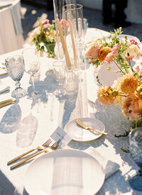 A table at a wedding reception in Charleston SC with the glassware casting shadows onto the table 