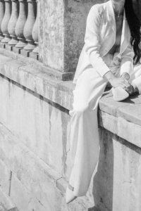 A  person elegantly seated on a historic balcony