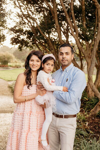 a family posing for a family portrait during their auckland family photoshoot with michelle kelly