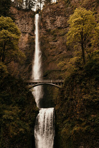 bridge in front of a waterfall