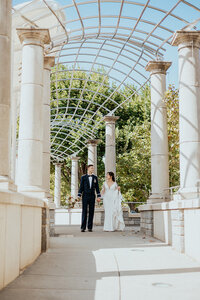 Bride and groom walking under skylight in Asheville, North Carolina
