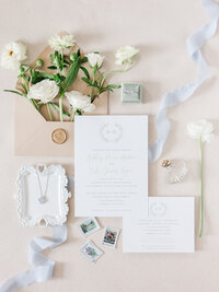 flat lay of white bridal shoes and white flowers
