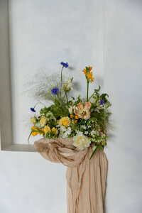 A gorgeous floral piece sits in a limewashed recessed wall.