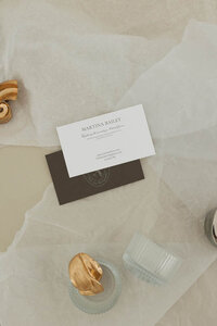 Minimalist business card mockup featuring the Martina Bailey Fine Art Photography brand design—part of a Canva brand kit for wedding photographers. Styled with soft paper textures, neutral tones, and elegant serif typography.