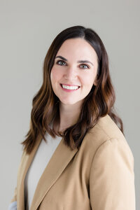 Heather wearing a pink sweater, smiling