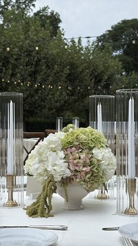 green white and light pink bouquet on a table at a wedding in cleveland, ohio, where kate's content co. is hired to take photos for a wedding day content creation