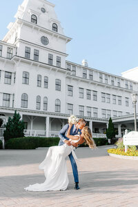 Photo of groom dipping bride while kissing her taken by Intimate wedding photographer Portland Maine