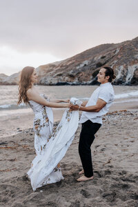 Destination Wedding Photographer captures couple holding hands on the beach