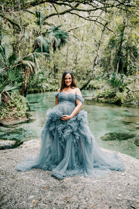 Pregnant woman in blue flowing dress at a Maternity session in Clearwater, FL