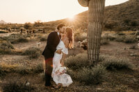 wedding shoot in the desert next to a cactus