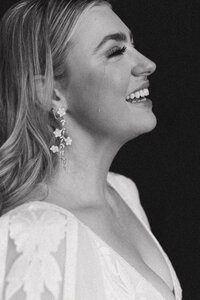 black and white photo of bride with a tear streaming down her face