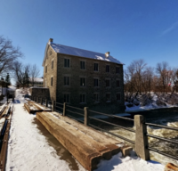 Couple standing outside a decorated storefront during Ottawa downtown Almonte mini session.