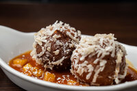 beignets in a white dessert dish