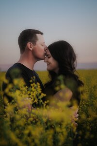 bride and groom reach for each other and barely touch at sand dunes in Nevada