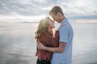 Lake Tahoe wedding photographer captures couple kissing during beach engagements