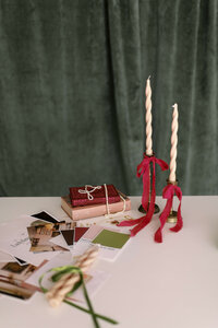 Books, candles, and color swatch cards on a table