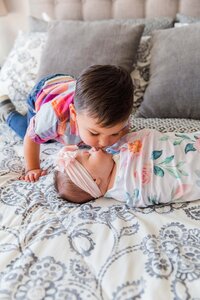 big brother kisses his newborn sister in Erie, CO