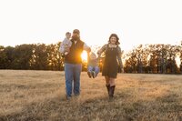 Golden hour family shoot in field of grass