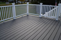 A grey deck with all white railings