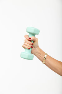 Woman's hand holding a dumbell