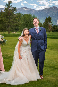 Jackson Hole photographers capture intimate elopement of bride and groom laughing