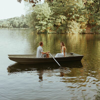 couple rowing a rowboat on a dreamy engagement session