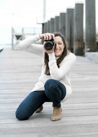 photographer with camera on dock