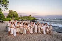Sunset beach family portrait with palm trees by a Big Island family photographer