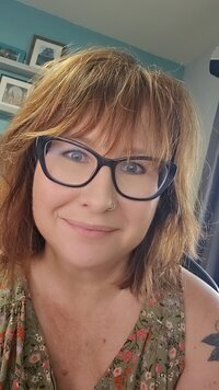 woman with short hair and bangs wearing black eyeglasses