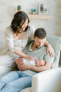 Philly couple in their nursery with their newborn and goldendoodle