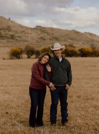 Engagement photo of a couple at sunset in Wyoming, with a romantic outdoor setting and soft natural lighting.