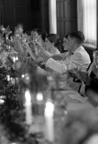 Wedding party lifting drinks for toast taken by chicago film wedding photographer Allison Francois