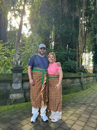 A couple celebrates their wedding in traditional attire, surrounded by nature. Destined specializes in planning destination weddings that honor diverse cultural experiences, providing personalized travel planning and luxury service.