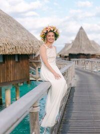 Moorea Photographer : Couple portrait looking at the camera with palms on the beach